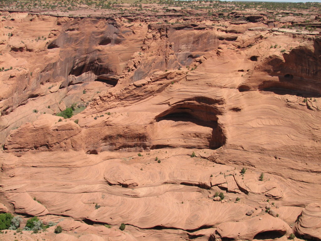 a  red sandstone cliff side in the desert 