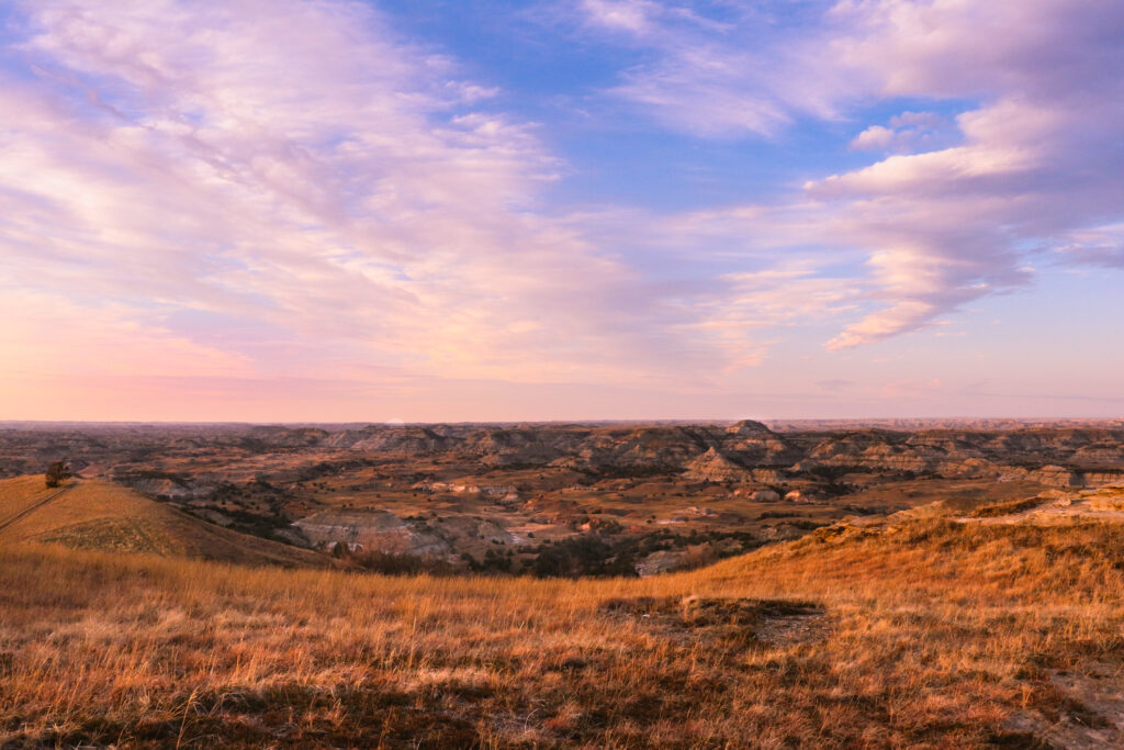 sunset over grassy hills